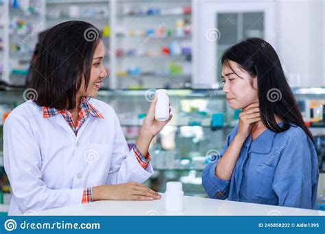 Doctor Female Explains Dispenses Medicationa And Gives Advice To Young