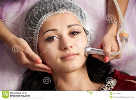 Close Up Woman Receiving Electric Ultrusound Facial Massage At Beauty