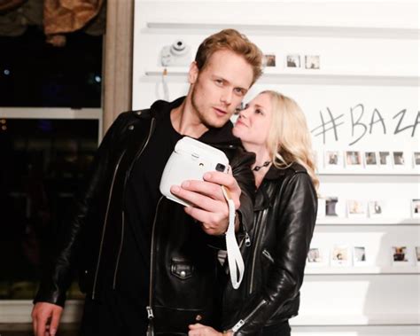 new hq pic of sam heughan and mackenzie mauzy at “icons” celebration by harper s bazaar