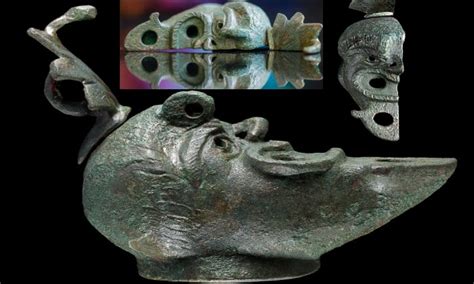 rare bronze oil lamp with a face cut in half unearthed in israel