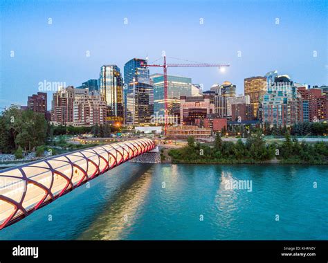 Calgary Downtown With Iluminated Peace Bridge And Full Moon Alberta