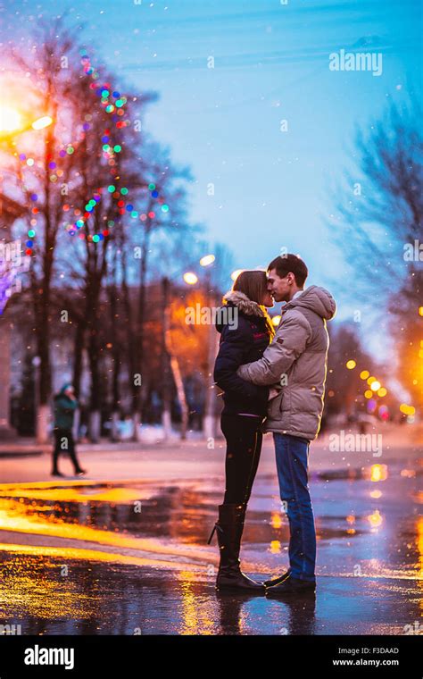In Love Couple Kissing In The Snow At Night City Street Filtered With