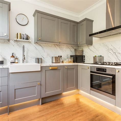 The dark grey kitchen island cabinets are contrasted perfectly with white countertops, the island worktop is made from quartz which has a marble effect vein running through it. Instead of tiles in the kitchen Grey kitchen Updated ...