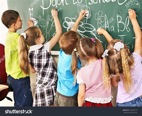 Children Writing On Blackboard At School Stock Photo 146100773