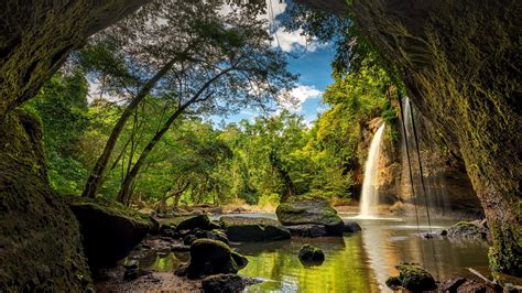 nature landscape tropical trees forest water rocks moss clouds sky cave waterfall