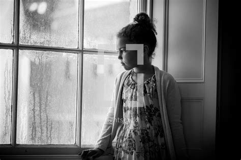 A Girl Sitting In A Window Watching The Rain — Photo — Lightstock