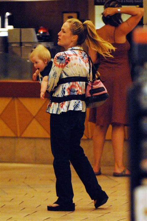 Gillian anderson obliges, posing genteelly. Gillian with cutie pie son, either Oscar or Felix.