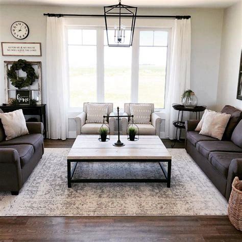 The living room is furnished with claret armchairs (right) and a hexagonal table by rose tarlow melrose house, along with a neutral rug by patterson flynn martin. Hillsby Oriental Charcoal/Light Gray/Beige Area Rug in ...