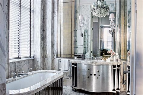 I love adding a mini crystal chandelier or empire chandelier with coordinating wall sconces to set the tone of a petite bathroom. Bathroom Chandelier Ideas | Architectural Digest