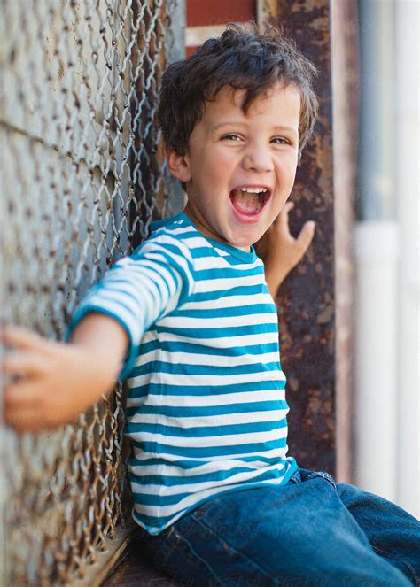 Young Boy Happy Laughing And Smiling In A Hipster Stripe Shirt By