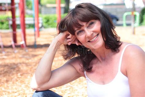 Beautiful Happy Mature Caucasian Woman Outside In The Park Stock Photo