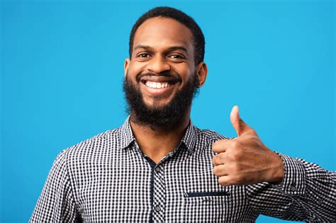 Happy Black Guy Gesturing Thumbs Up And Smiling Stock Photo Download