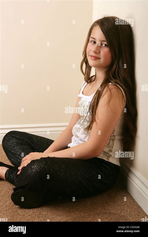 Portrait Of A Pretty 11 Year Old Girl Sitting Crossed Legged Stock