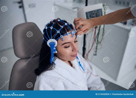 Clinical Neurophysiologist Preparing The Patient For The