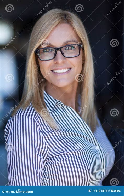 Pretty Mature Businesswoman Smiling At The Camera She Wears Glasses