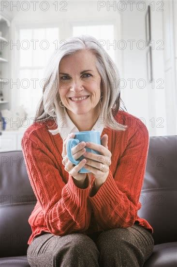 Portrait Of Caucasian Woman Drinking Coffee On Sofa Photo12 Tetra
