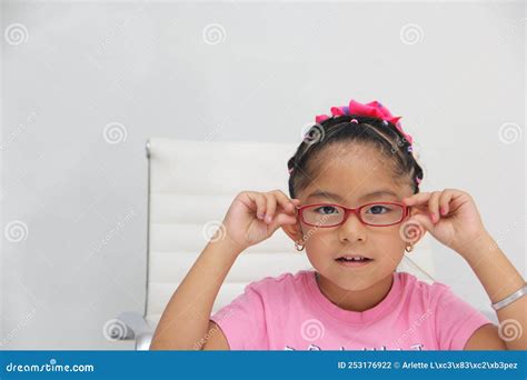 Brunette Latin Girl Shows Her Red Glasses To See Better Because She Has Myopia And Astigmatism