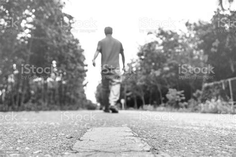 Black And White At Countryside Road And Young Man Walking Alone On The