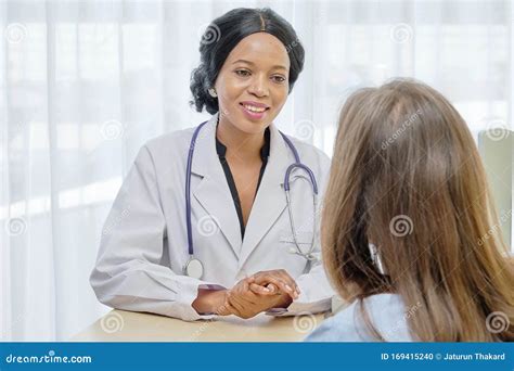 Black African Female Doctor Consulting With European Patient About Her