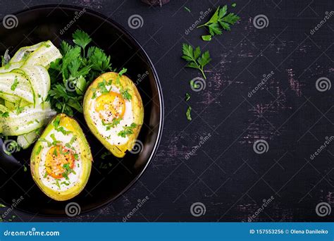 Avocado Baked With Egg And Fresh Salad Vegetarian Dish Stock Photo