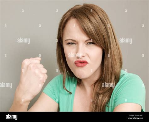 Portrait Of An Angry Bad Tempered Young Caucasian Woman Frowning And