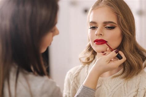 Premium Photo Makeup Artist Applies Red Lipstick Hand Of Makeup