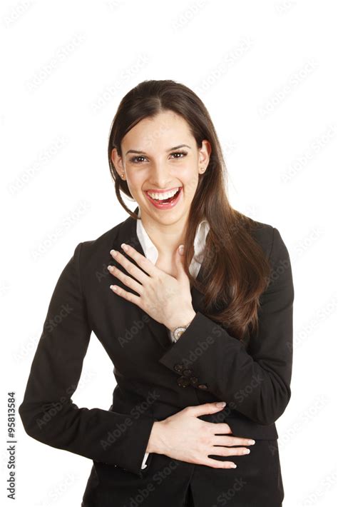 A Young Woman Laughing Hysterically With Her Hands To Her Body Stock
