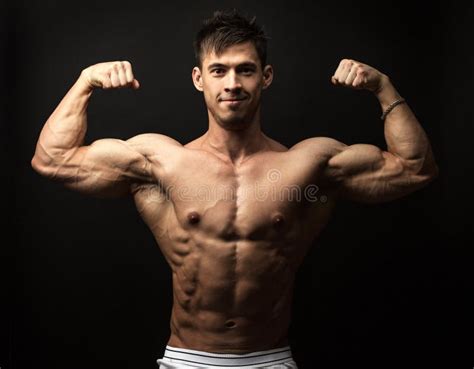 Waist Up Portrait Of Muscular Man Flexing His Biceps Stock Image