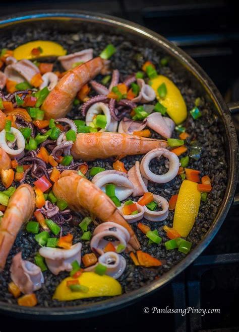 Paella is a spanish rice dish originally from valencia. Paella Negra (Arroz Negre) Recipe - Panlasang Pinoy