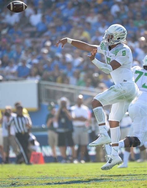 Marcus Mariota 8 Of The Oregon Ducks Throws Across His Body For A 36