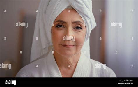 old caucasian middle aged woman mature lady elderly model female with towel on head in bathrobe