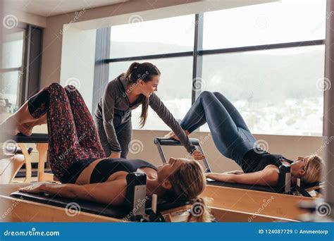 Pilates Trainer Instructing Women At The Gym Stock Image Image Of