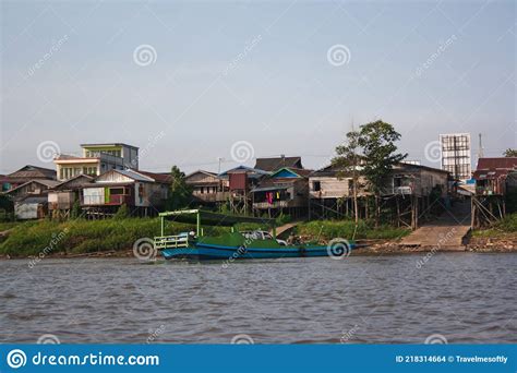 Stilt Houses And Transport Boat On The Bank Of The River Mahakam Stock