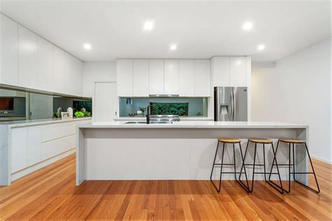 If you like your kitchen relaxing and inviting, go with all white. White L shaped kitchen Long Waterfall Island | Apartment furniture, Furniture, Cheap furniture
