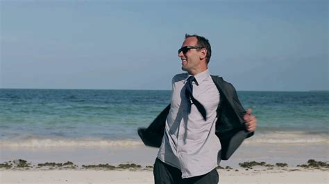 Happy Businessman Taking Off Clothes On Beach Stock Footage Sbv