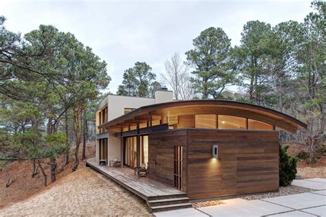 Contemporary Forest House With Curved Metal Roof
