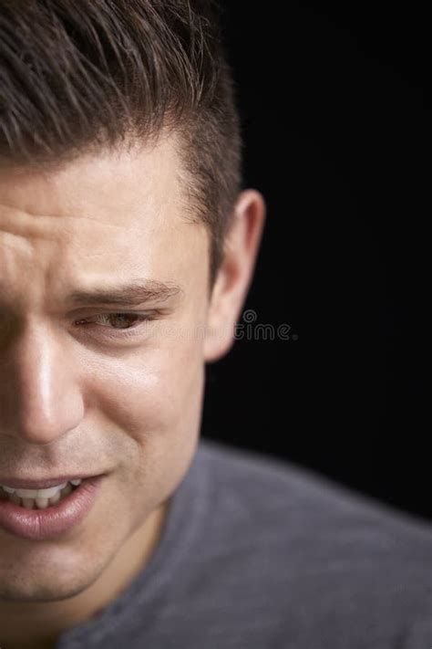 Close Up Of Crying Young White Man Looking Down Horizontal Stock Image