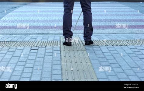 Lone Blind Man Detecting Tactile Tiles Walking To Pedestrian Crossing