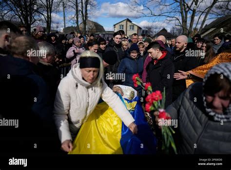 Oksana Bondarenko Adjusts The Ukrainian Flag On The Coffin Of Her Brother Vladyslav Bondarenko