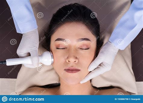 Woman Receiving Ultrasound Facial Beauty Treatment Skin Care Stock