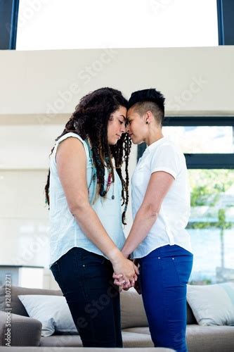 Romantic Lesbian Couple Standing Face To Face And Holding Hands Buy