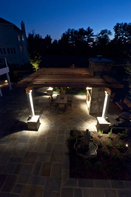 Projected lighting keeps this patio feeling atmospheric and the yard's unique landscaping is perfectly showcased through the yard's lighting. Flagstone patio with landscape lighting - Patio ...