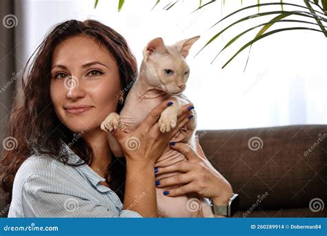 Portrait Of Young Woman Holding Cute Cat With Blue Eyes Female Hugging