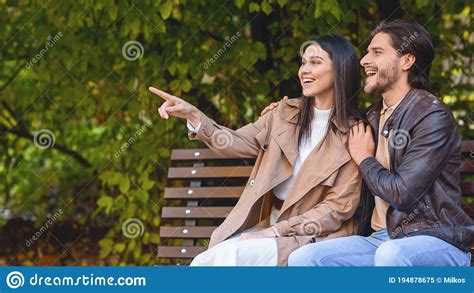 Emotional Girl Showing Something Her Boyfriend Pointing At Copy Space