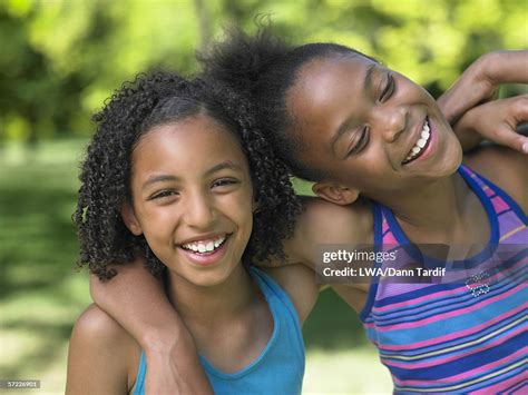Portrait Of Two Girls Hugging And Laughing Photo Getty Images