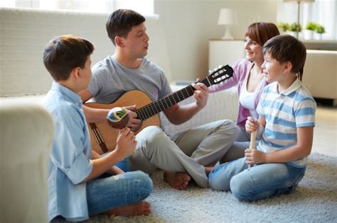 Father Playing Guitar At Home Photo Free Download