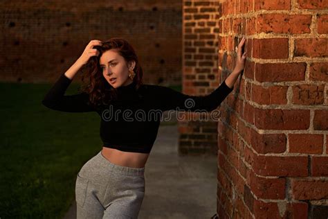 Portrait Of A Beautiful Sensual Redhead Girl Posing In Sunset Sunlight