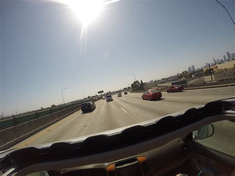 the sun is shining brightly over cars driving on an interstate highway in los angeles california