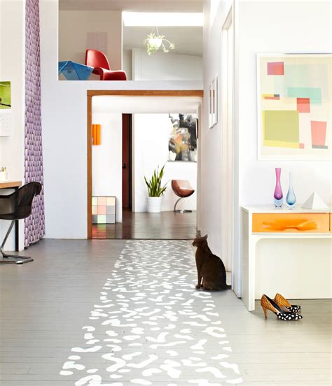 You can use concrete floor paint to make your concrete floor look as if it's tiled. Top 10 Stencil and Painted Rug Ideas for Wood Floors