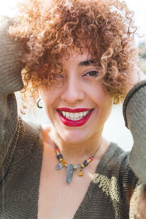 Hispanic Woman Smiling At Camera Portrait By Giorgio Magini Curly